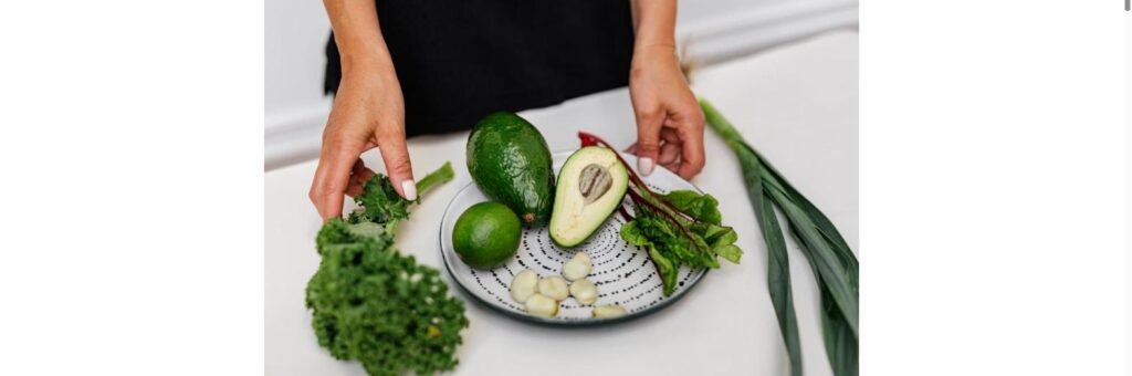 Fresh avocado, kale, lime and garlic on a plate for gut-friendly eating