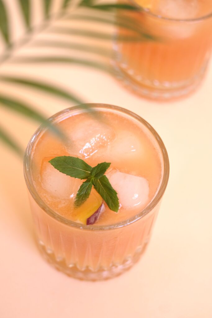 Pink cortisol cocktail mocktail drink garnished with mint, a viral wellness trend