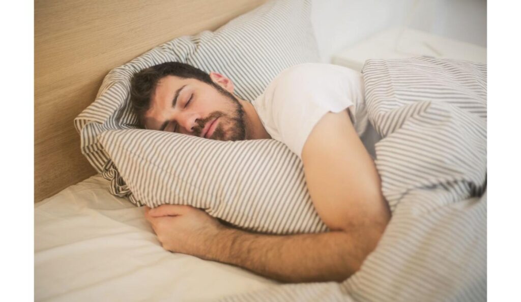 Man sleeping peacefully at night as part of a sleep optimization routine