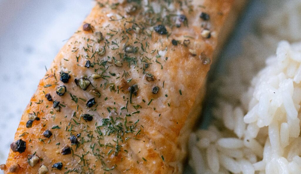 Seasoned air fryer salmon fillet served with rice