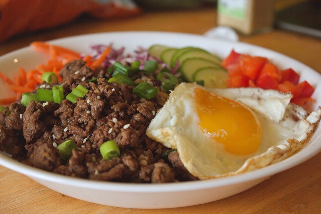 Korean ground beef bowl with rice, fried egg, and sesame seeds