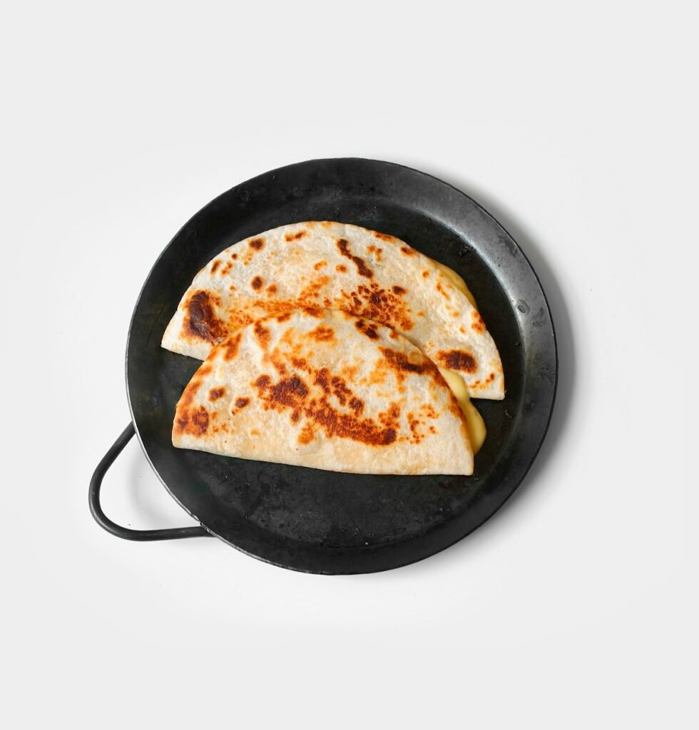 Chicken quesadilla cooking in a skillet