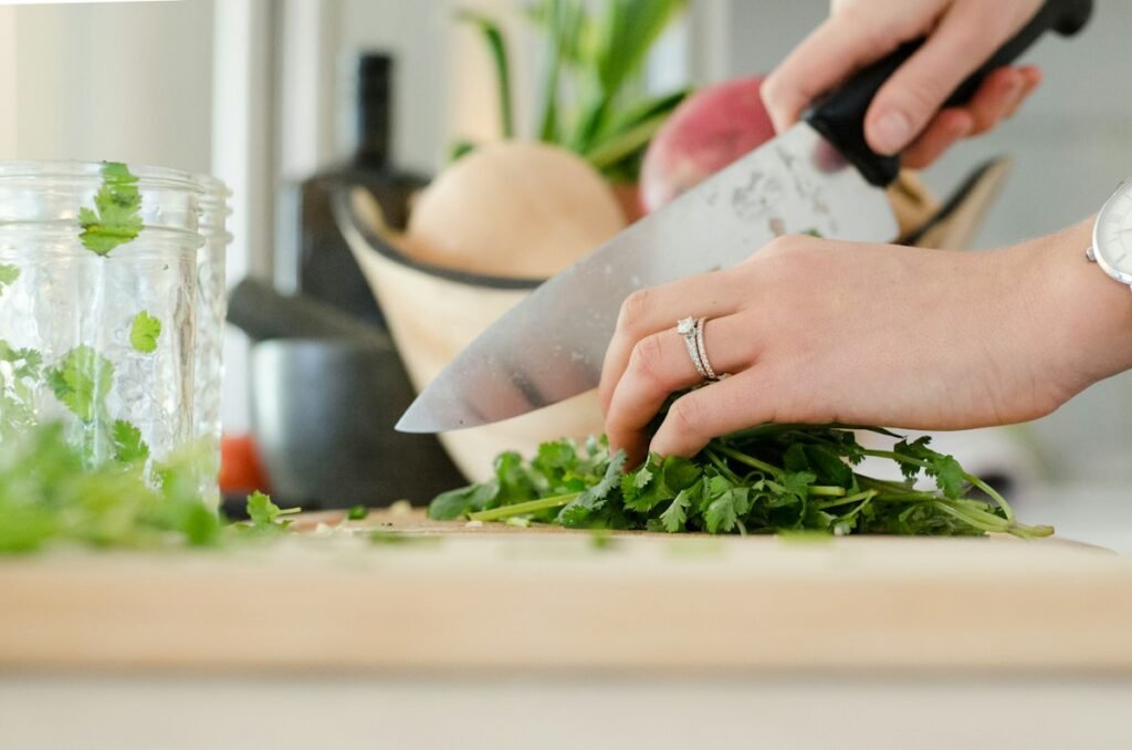 Chopping fresh vegetables on a cutting board for meal prep