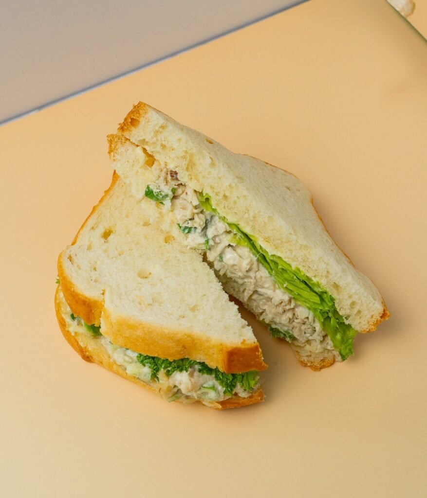 Creamy Greek yogurt chicken salad sandwich cut in half