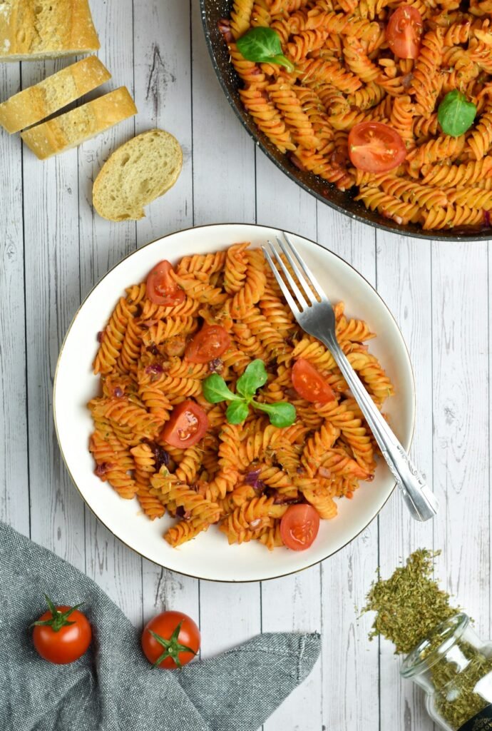 Creamy tomato pasta served on a white plate