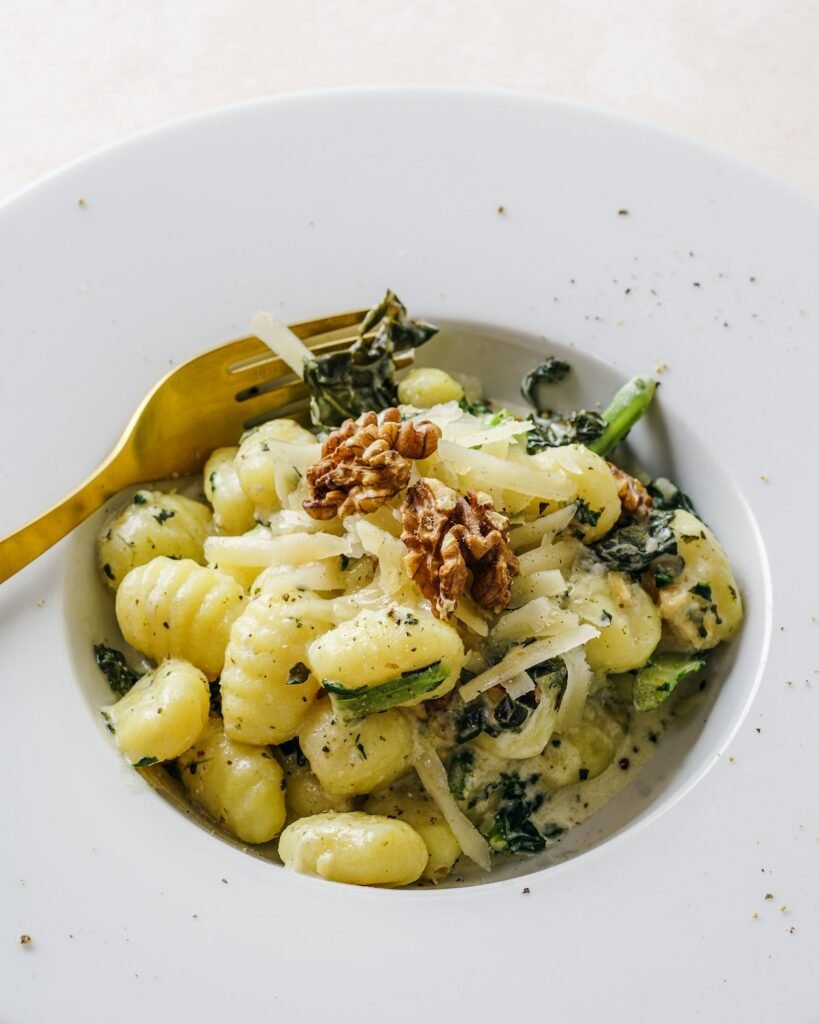 Creamy Tuscan gnocchi with spinach in a white bowl