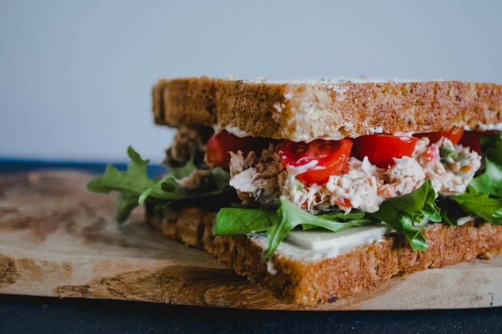 Greek yogurt chicken salad sandwich on whole grain bread with greens
