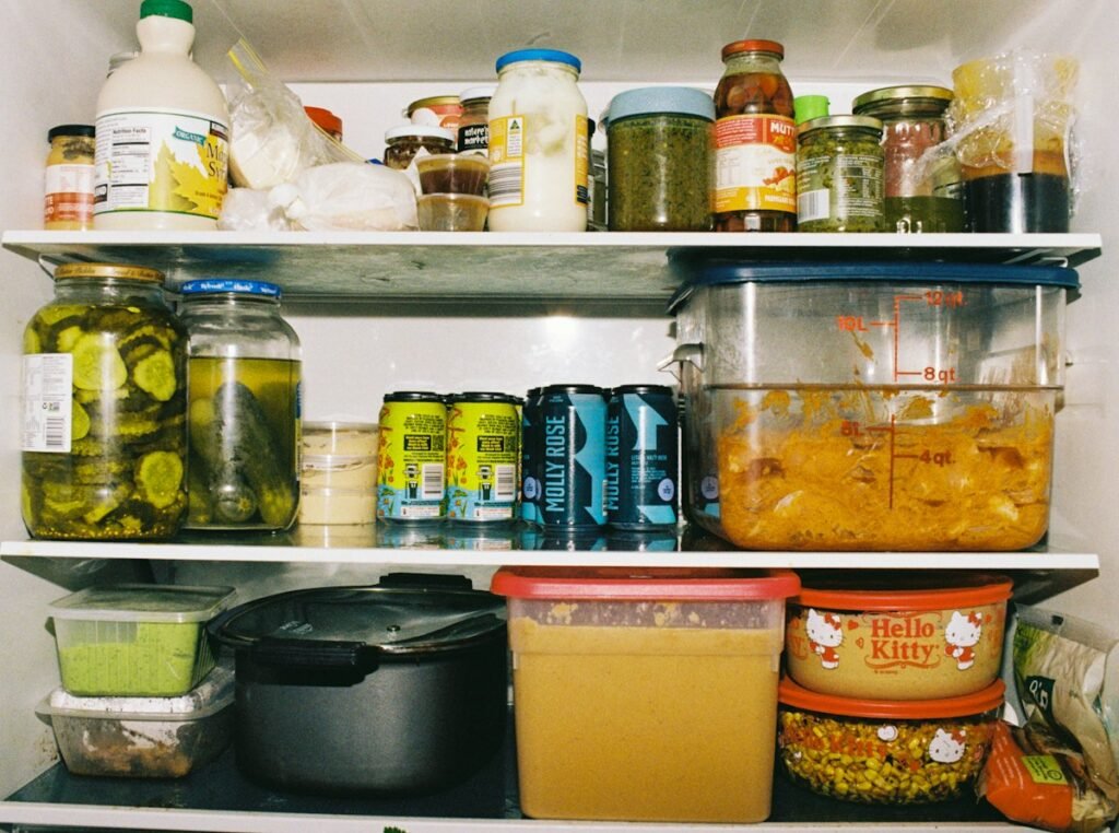 Refrigerator shelves with containers of leftover food