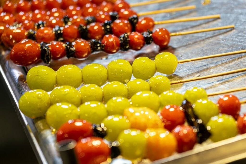 Tanghulu candied fruit skewers with grapes, strawberries and tangerines